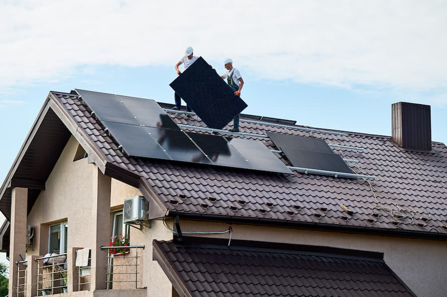 people installing home solar panels
