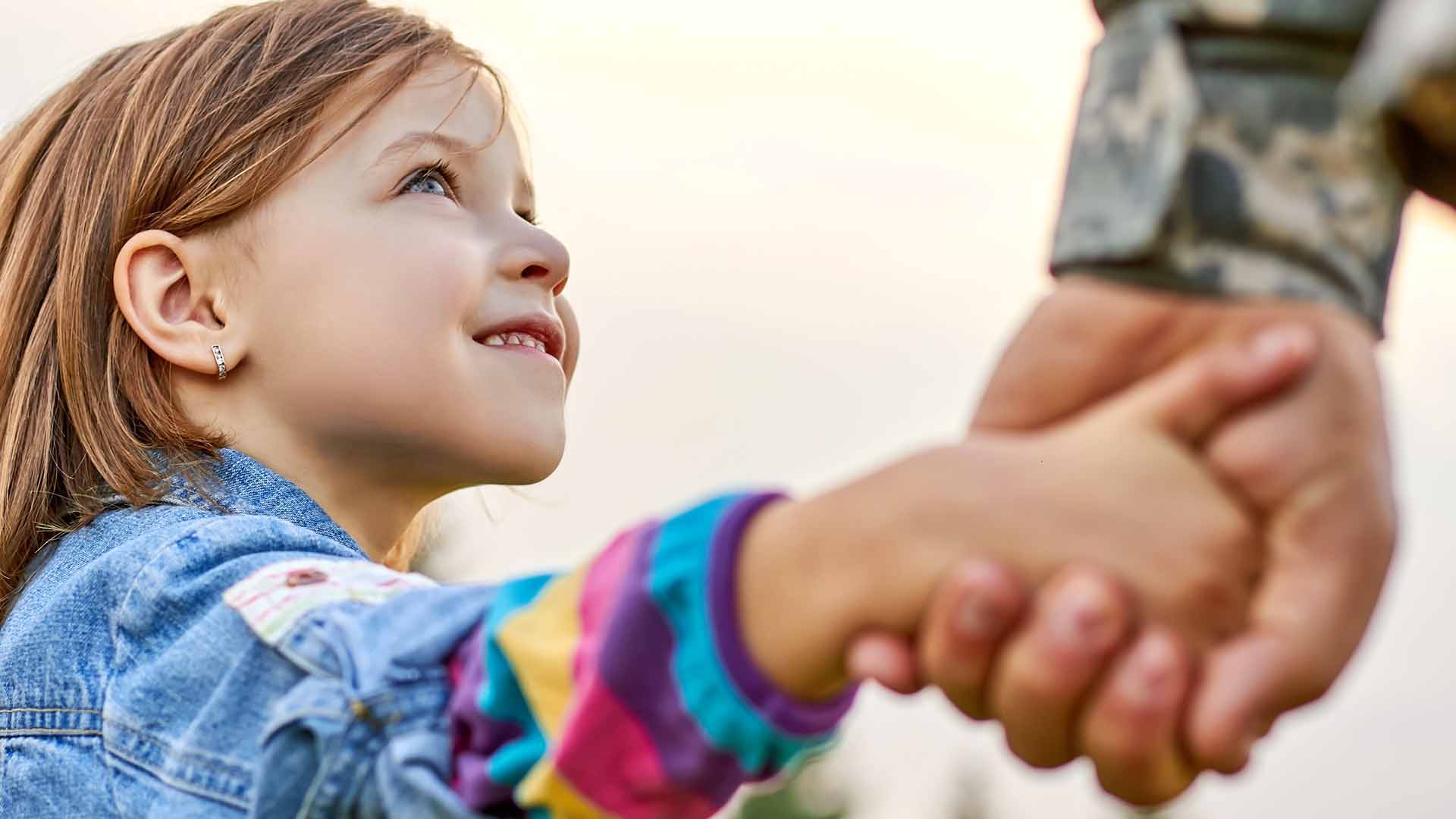 Child holding father's hand