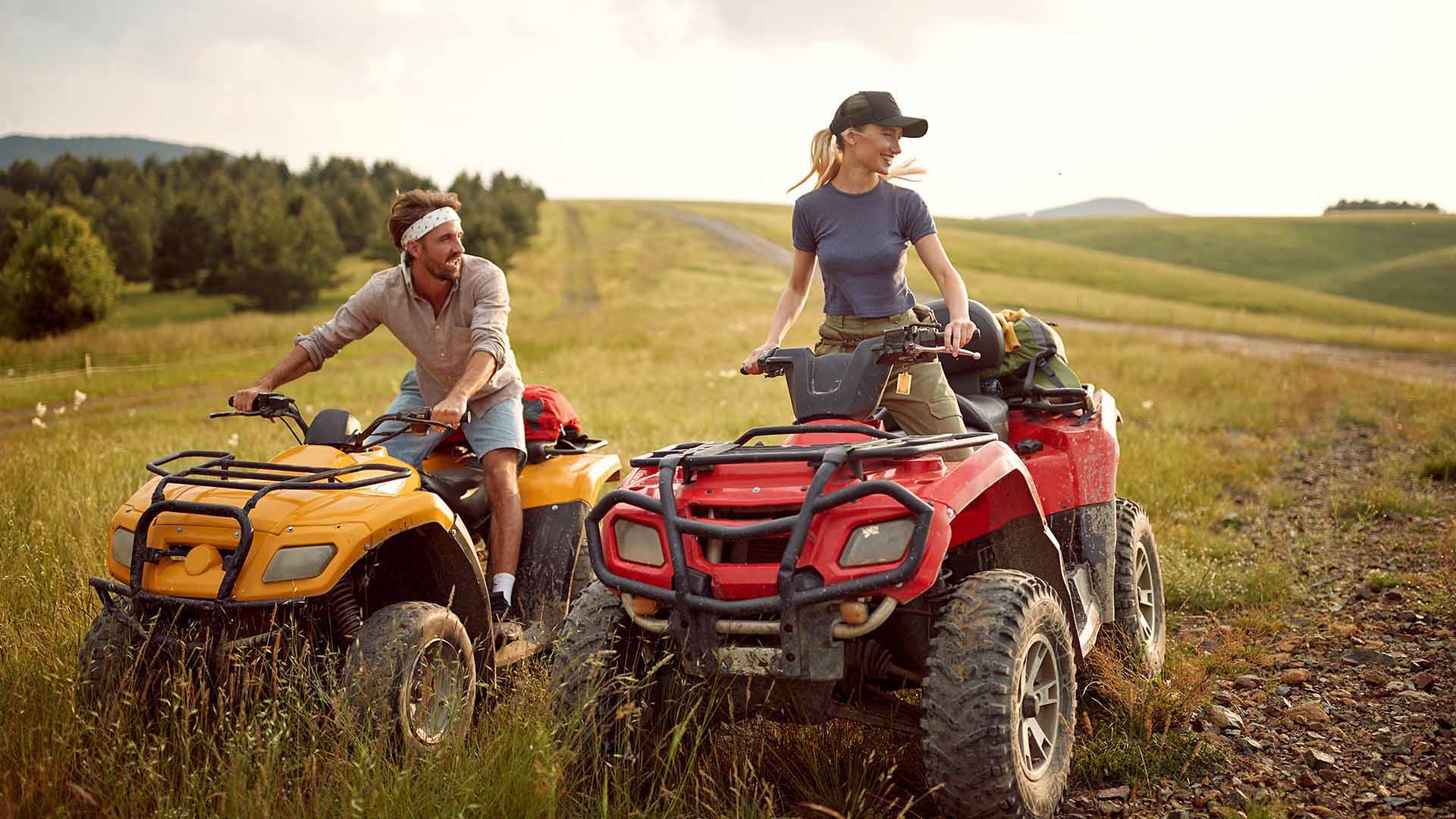 Couple riding ATVs