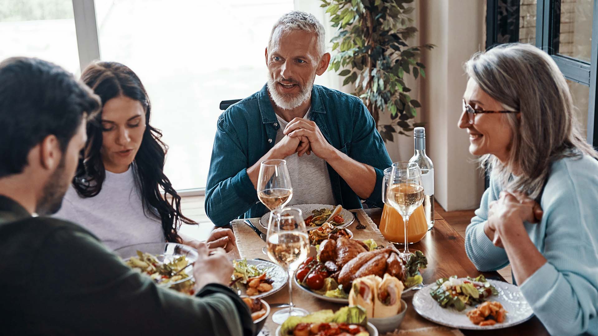 Family of adults eating a meal at a table