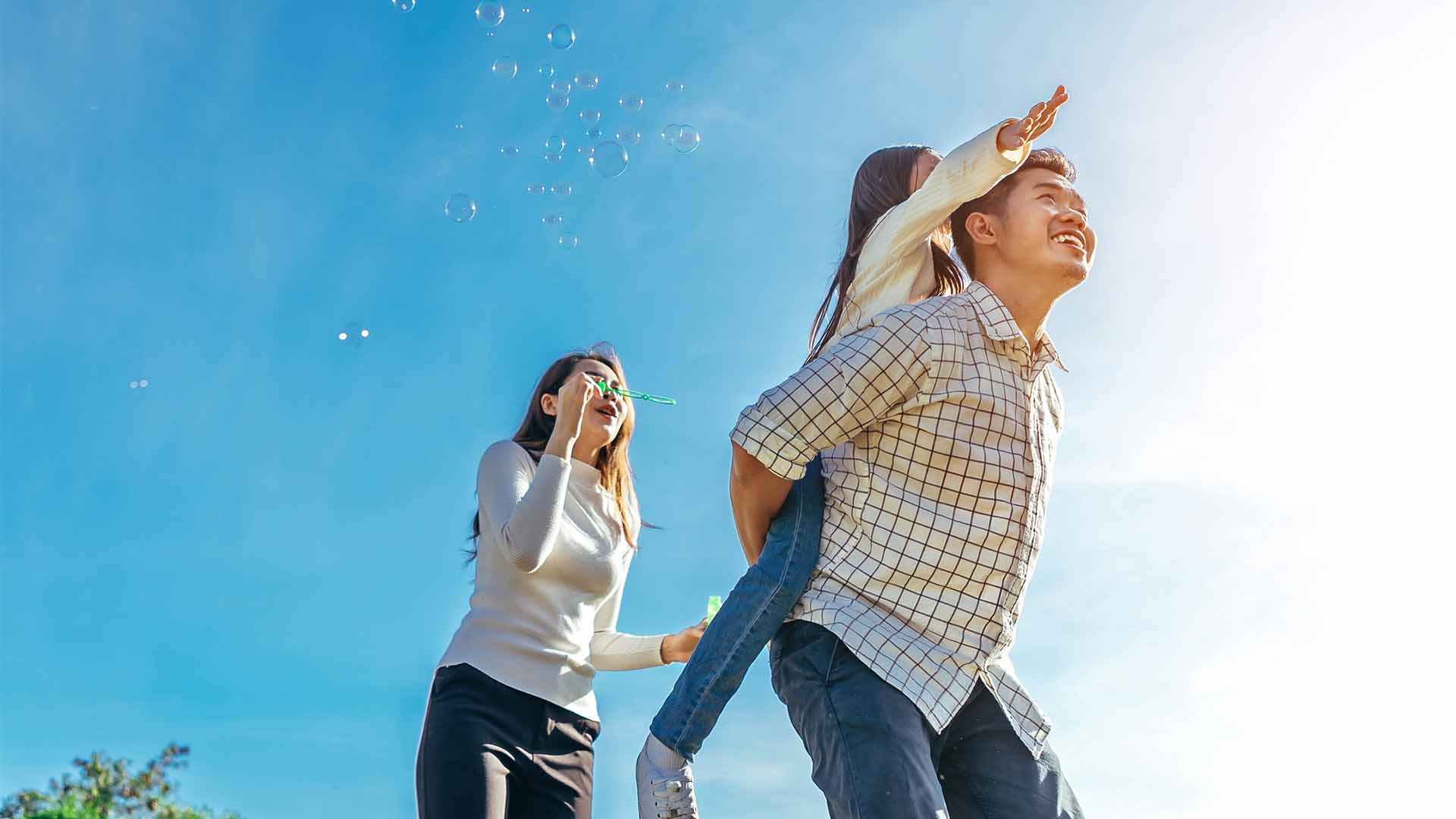 Parents blowing bubbles with child