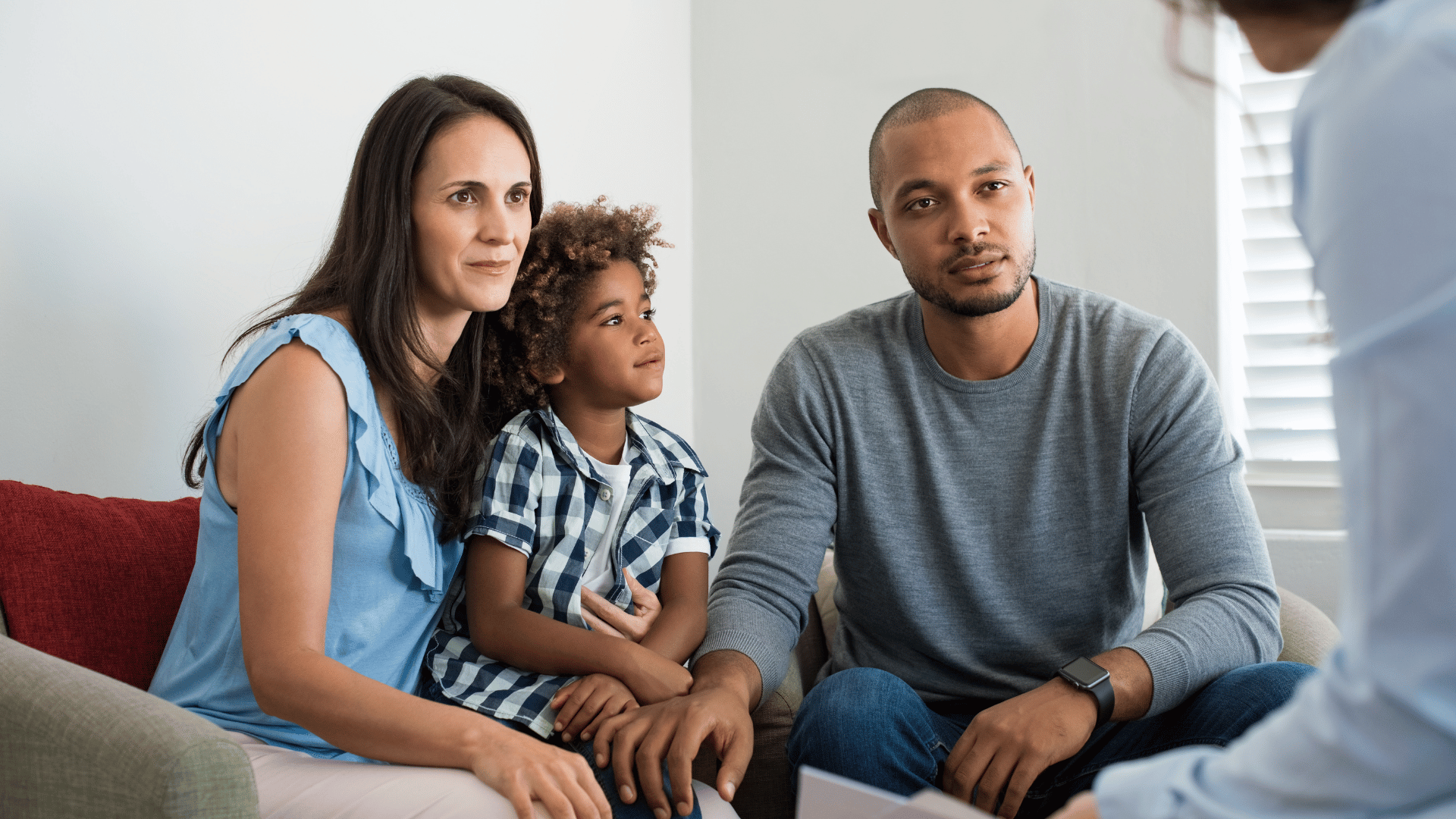 Family consisting of mom, dad, and child receiving information about financial assistance and hardship
