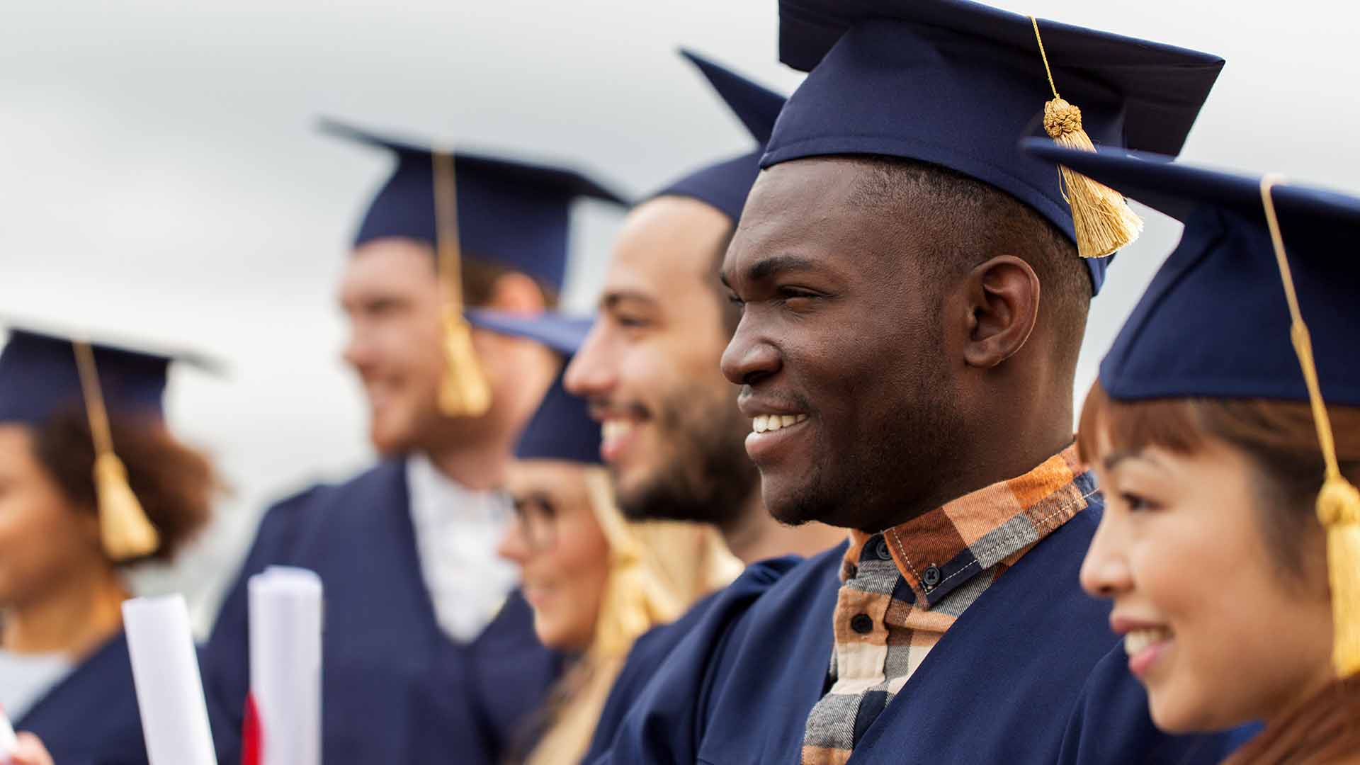 Group of students holding diplomas