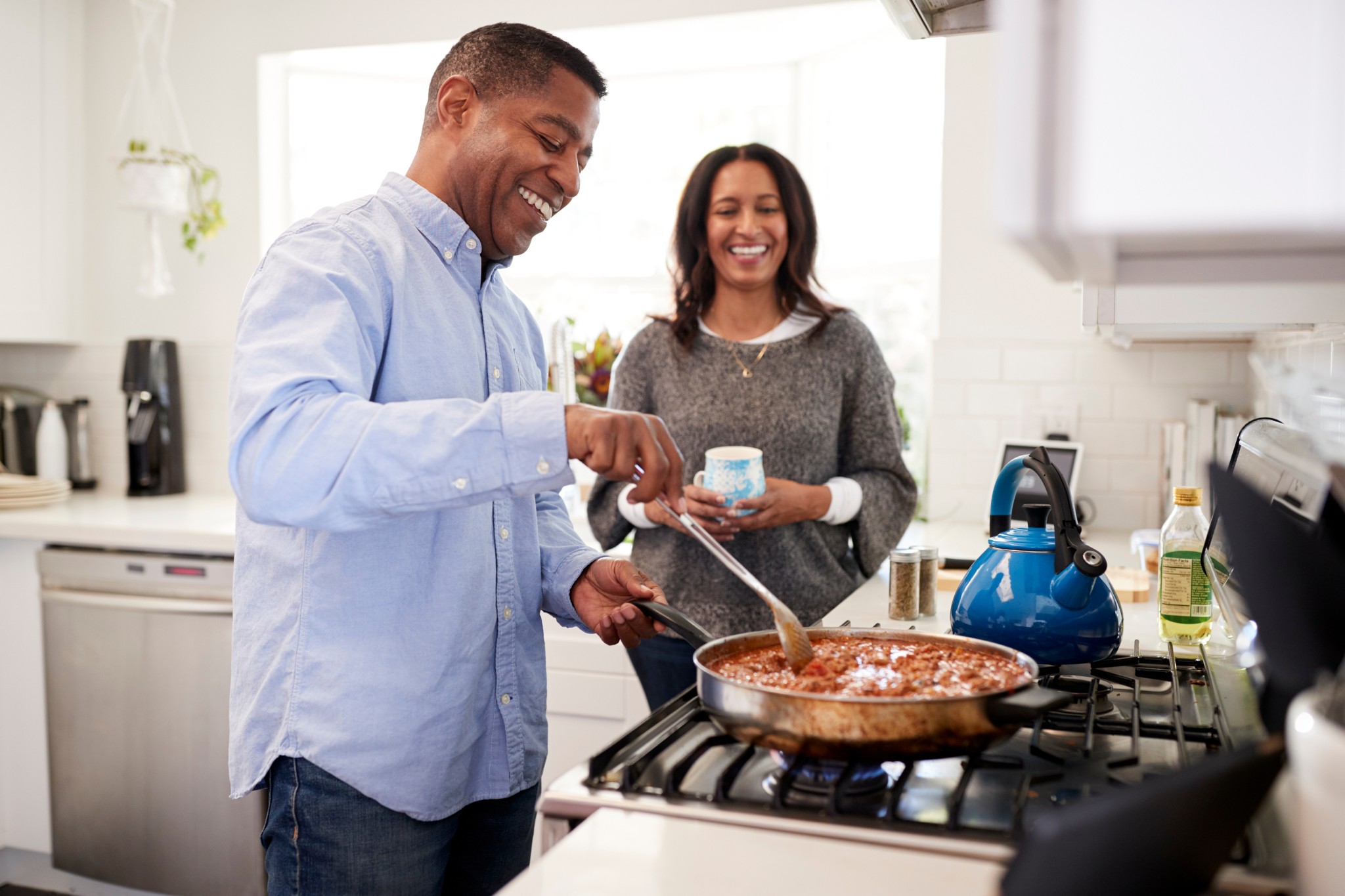 happy couple cooking dinner