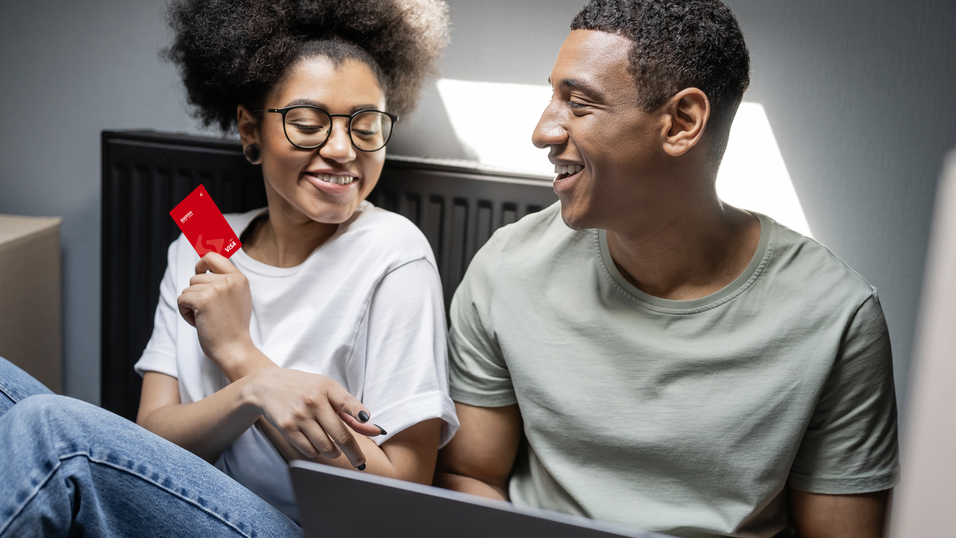 Playful Couple reviewing finances on laptop