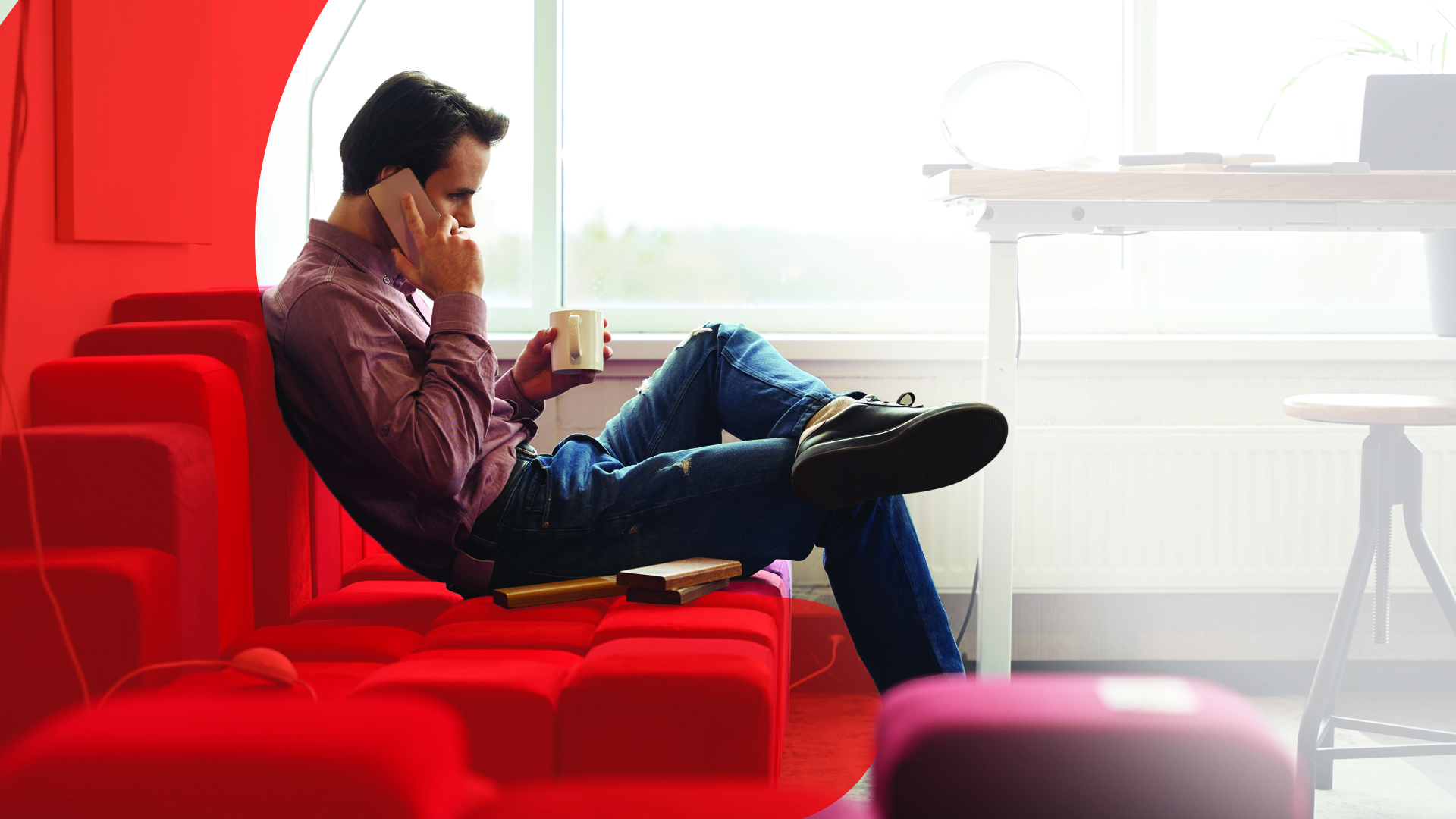 Man sitting on modern furniture on a phone call