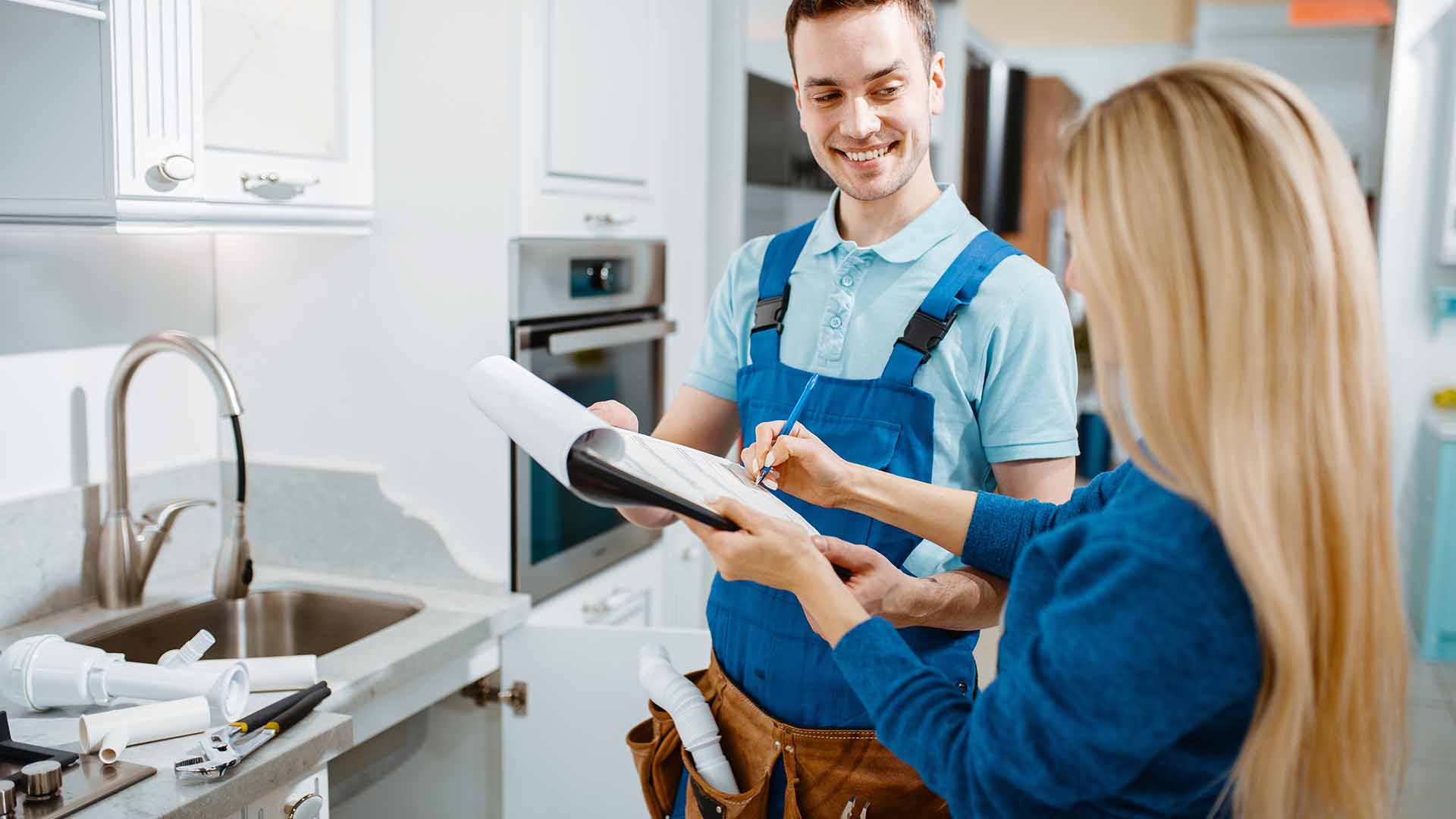 Woman signing for plumbing repair expense