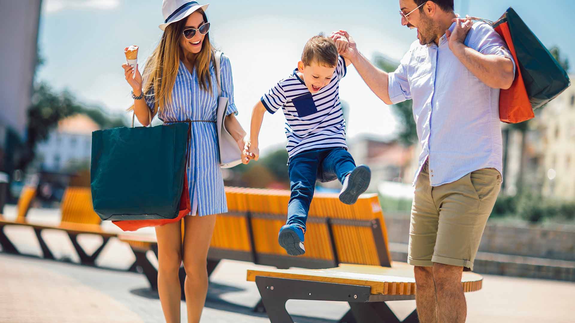 Couple Swinging Son while out shopping