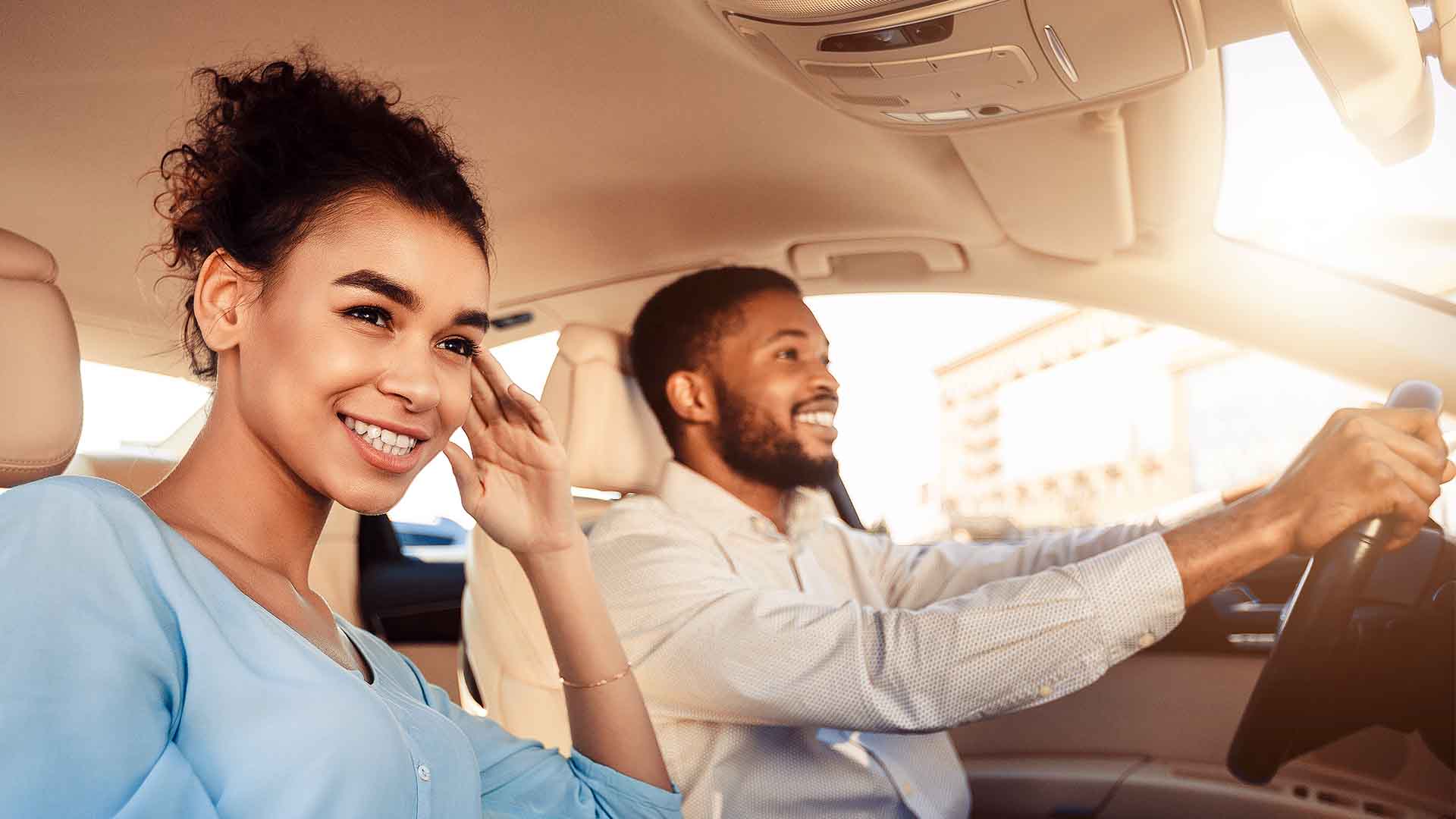 Home Auto Loan Young couple driving in new car