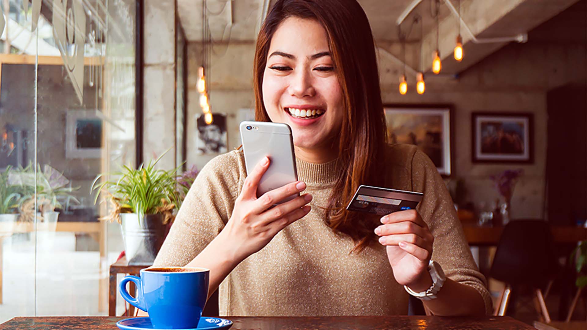 Young woman holding credit card