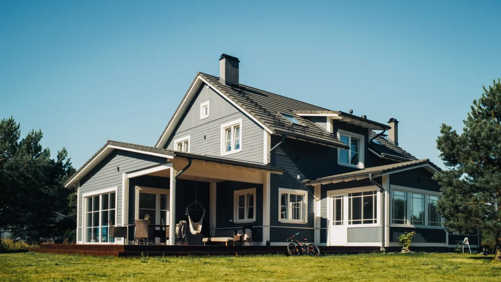 Modern two-story home on a green lawn under a clear sky